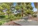 Patio area with a table and chairs, surrounded by lush greenery at 7232 Vista Bonita Dr, Las Vegas, NV 89149