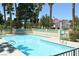 Refreshing community pool surrounded by lush greenery and palm trees, perfect for relaxation at 7232 Vista Bonita Dr, Las Vegas, NV 89149