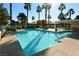 Sparkling community pool with palm trees, lounge chairs, and a shaded area at 7232 Vista Bonita Dr, Las Vegas, NV 89149