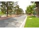 Charming street view with mature trees, manicured lawns, and a paved road lined with well-kept landscaping at 7232 Vista Bonita Dr, Las Vegas, NV 89149
