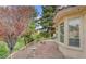 Lush backyard with mature trees, landscaping and a walking path at 7232 Vista Bonita Dr, Las Vegas, NV 89149