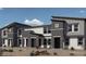 Modern townhome exterior showcasing a contemporary design with neutral tones and well-maintained landscaping at 7351 Kyle Cove Dr # Lot 208, North Las Vegas, NV 89084