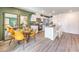 Open kitchen and dining area with stainless steel appliances, white cabinetry, and contemporary decor at 7351 Kyle Cove Dr # Lot 208, North Las Vegas, NV 89084
