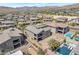 Aerial view showcases the outdoor living space, featuring a pool, fire pit, and desert landscaping at 754 Tallgrass St, Las Vegas, NV 89138