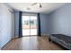 Well-lit bedroom features a sliding glass door to the backyard patio with wood-look floors at 754 Tallgrass St, Las Vegas, NV 89138