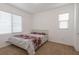 Carpeted bedroom with two windows and a queen bed with floral bedspread at 754 Tallgrass St, Las Vegas, NV 89138