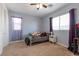 This bedroom features light-blue walls, carpet flooring, and a large window that lets in plenty of natural light at 754 Tallgrass St, Las Vegas, NV 89138