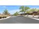 Community entrance featuring stone accents, wrought iron gates, desert landscaping, and gorgeous mountain views at 754 Tallgrass St, Las Vegas, NV 89138