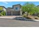 Contemporary two-story home featuring a three-car garage, xeriscaped yard and mature shade tree at 754 Tallgrass St, Las Vegas, NV 89138