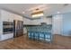 Well-equipped kitchen with stainless steel appliances, granite counters, and a stylish lighting fixture at 754 Tallgrass St, Las Vegas, NV 89138