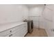 Bright laundry room with white cabinets, countertop space, and newer washing machine at 754 Tallgrass St, Las Vegas, NV 89138