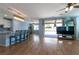 Bright open-concept living area featuring wood floors, modern lighting, and backyard access at 754 Tallgrass St, Las Vegas, NV 89138