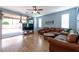 Comfortable living room with wood floors, leather furniture and sliding glass doors leading to a patio at 754 Tallgrass St, Las Vegas, NV 89138