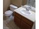 Cozy bathroom with a white toilet, vanity, sink, and tile flooring in a neutral palette at 7701 W Robindale Rd # 259, Las Vegas, NV 89113