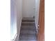 Entryway featuring a staircase with carpeted steps, white trim, and a view of the upper level at 7701 W Robindale Rd # 259, Las Vegas, NV 89113