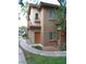 Charming two-story home with neutral stucco, a terracotta roof, and a tidy, desert-style front yard at 7701 W Robindale Rd # 259, Las Vegas, NV 89113