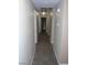Neutral colored hallway with carpet, lighting and doorways visible in a residential home at 7701 W Robindale Rd # 259, Las Vegas, NV 89113