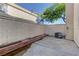 Exterior backyard featuring an AC unit and retaining wall with greenery at 7968 Lisa Dawn Ave, Las Vegas, NV 89147
