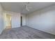 A bright bedroom featuring a ceiling fan and convenient access to the bathroom and closet at 7968 Lisa Dawn Ave, Las Vegas, NV 89147