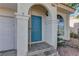Inviting front entrance with a blue door, tiled porch, and arched entryway at 7968 Lisa Dawn Ave, Las Vegas, NV 89147