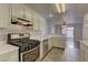 Charming kitchen with white cabinets, stainless steel appliances, and tile flooring near dining area at 7968 Lisa Dawn Ave, Las Vegas, NV 89147