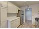 A cozy kitchen featuring bright white cabinets and modern stainless steel appliances at 7968 Lisa Dawn Ave, Las Vegas, NV 89147