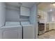 Convenient laundry area adjacent to the kitchen, equipped with a washer and dryer at 7968 Lisa Dawn Ave, Las Vegas, NV 89147
