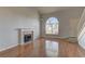 Bright living room featuring a fireplace, hardwood floors, and large windows at 7968 Lisa Dawn Ave, Las Vegas, NV 89147