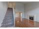 Spacious living room with a cozy fireplace, staircase, and hardwood floors at 7968 Lisa Dawn Ave, Las Vegas, NV 89147