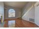 Bright and airy living room with hardwood floors, fireplace, and large arched window at 7968 Lisa Dawn Ave, Las Vegas, NV 89147