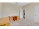 Bedroom with a wooden desk, an open closet, and a doorway to the laundry room, perfect for organization at 8116 Kokoma Dr, Las Vegas, NV 89128