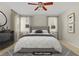 This staged bedroom features neutral tones and a decorative ceiling fan at 8116 Kokoma Dr, Las Vegas, NV 89128