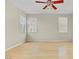 An empty bedroom features neutral walls, wood floors, and lots of natural light at 8116 Kokoma Dr, Las Vegas, NV 89128