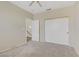 Bedroom featuring closet space, neutral carpet, and access to an adjacent stairway, providing a flexible layout at 8116 Kokoma Dr, Las Vegas, NV 89128