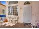 Inviting front entrance with security door and charming seating area perfect for enjoying a morning coffee at 8116 Kokoma Dr, Las Vegas, NV 89128