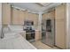 Functional kitchen with stainless steel refrigerator and gas range stove offering modern cooking solutions at 8116 Kokoma Dr, Las Vegas, NV 89128