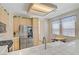 Bright eat-in kitchen featuring white tile countertops, stainless steel fridge and cozy breakfast nook at 8116 Kokoma Dr, Las Vegas, NV 89128