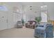 Bright and spacious living room featuring large windows and comfortable seating, perfect for relaxation at 8116 Kokoma Dr, Las Vegas, NV 89128