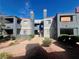 Exterior of condominium building featuring desert landscaping, multiple floors, and a pathway at 8600 W Charleston Blvd # 2033, Las Vegas, NV 89117