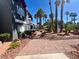 Lush landscaping surrounds an apartment complex, with paved walkway and tall palm trees at 8600 W Charleston Blvd # 2033, Las Vegas, NV 89117