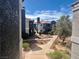Landscaped condo complex featuring desert landscaping, multiple floors, and a pathway between buildings at 8600 W Charleston Blvd # 2033, Las Vegas, NV 89117