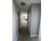 Hallway featuring wood-look flooring and neutral gray paint leading into a living room with a fireplace at 8600 W Charleston Blvd # 2033, Las Vegas, NV 89117