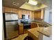 Kitchen boasts stainless steel appliances, wood cabinets, and granite countertops at 8600 W Charleston Blvd # 2033, Las Vegas, NV 89117