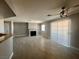 Large living area with fireplace, wood floors, and ceiling fan at 8600 W Charleston Blvd # 2033, Las Vegas, NV 89117