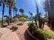 Sparkling community pool with surrounding lush landscaping featuring palm trees and lounge seating at 8600 W Charleston Blvd # 2033, Las Vegas, NV 89117