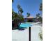 Community pool area featuring a pool house, lush landscaping, and comfortable lounge chairs for relaxation at 8600 W Charleston Blvd # 2033, Las Vegas, NV 89117