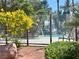 A sparkling community pool, complemented by lush greenery and comfortable lounge chairs for relaxation at 8600 W Charleston Blvd # 2033, Las Vegas, NV 89117