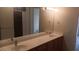 Bathroom features a dual sink vanity with large mirror and good lighting at 864 Chianti Way, Mesquite, NV 89027