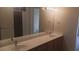 Elegant bathroom vanity with double sinks, a large mirror, and ample counter space at 864 Chianti Way, Mesquite, NV 89027