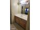 Well-lit bathroom vanity with cabinets and view of the bedroom reflected in the mirror at 864 Chianti Way, Mesquite, NV 89027